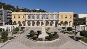 A large building with a central courtyard, multiple arches, and a statue. - Poet's Square Modern Residence 2 (Zakinthos)