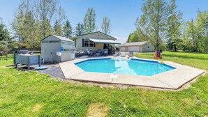 A residential property with a swimming pool, a covered patio, and a small shed. - Brand new listing!!! Relax and unwind at this stunning Northwoods pool house featuring a private in-ground pool, fire pit, patio, garage space, and sleeping for 11 guests! (Mountain)
