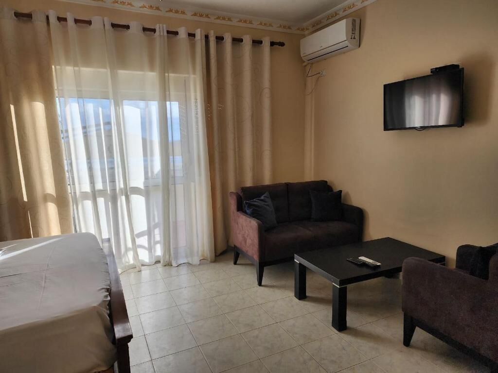 Quarto triplo luxo, sacada, vista para o mar | Área de estar
