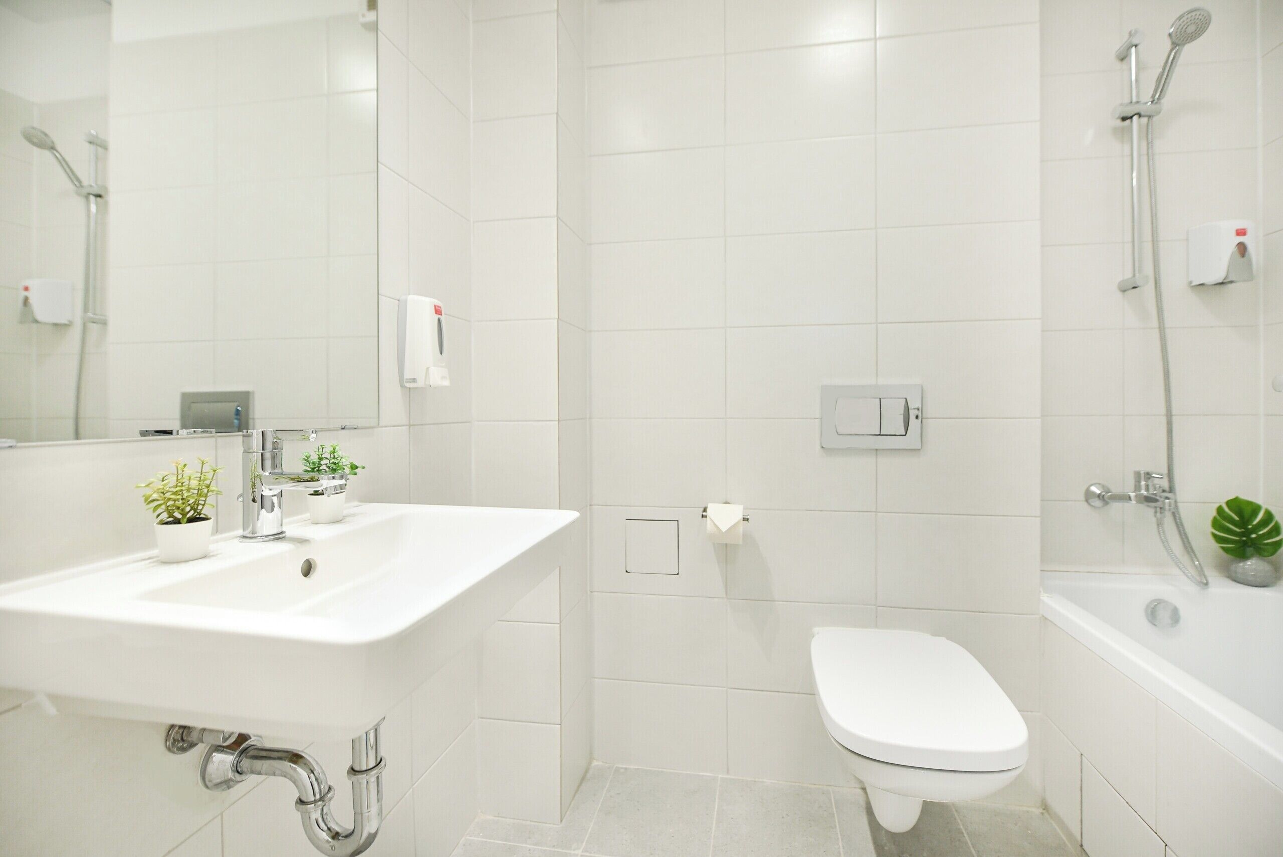 A bathroom with a sink, toilet, and shower.