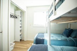 A bedroom with bunk beds, a wardrobe, and a window. - Sunrise on Sawmill - Kayaks, Paddleboat, Firepit, Arcade! (Leesburg)