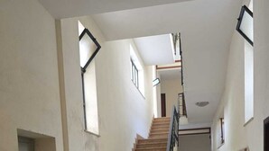 A staircase with a handrail, a landing area, and a ramp leading to an upper floor. - BnB Short-term rental Palermo Center, vacation home apartment (Palermo)