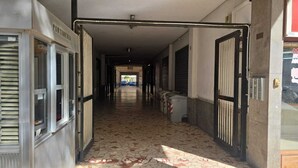 A corridor with tiled flooring, metal doors, and a visible exit at the end. - BnB Short-term rental Palermo Center, vacation home apartment (Palermo)