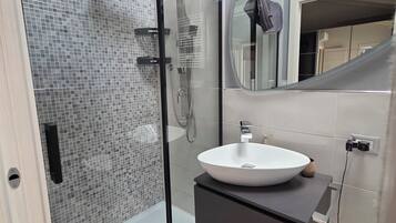 Een douche, een haardroger, een bidet, handdoeken