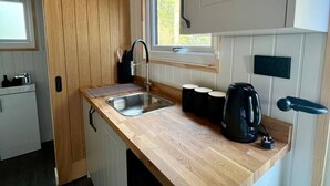 A compact kitchen with a wooden countertop, a sink, and a kettle. - Woodland get away 0.7 mile walk from the beach ! (Mawgan Porth)