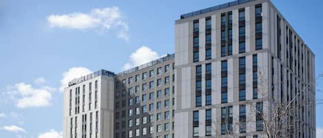 A multi-story building with a grid of windows and a flat roof.