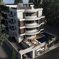 A modern multi-story building with balconies, a swimming pool, and a carport.