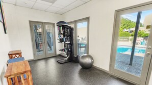 A gym with exercise equipment, a wooden bench, and a large exercise ball. - Quiet & Relaxing 2BR - King Bed/Pool/Gym Near UAB/Hospitals (Homewood)