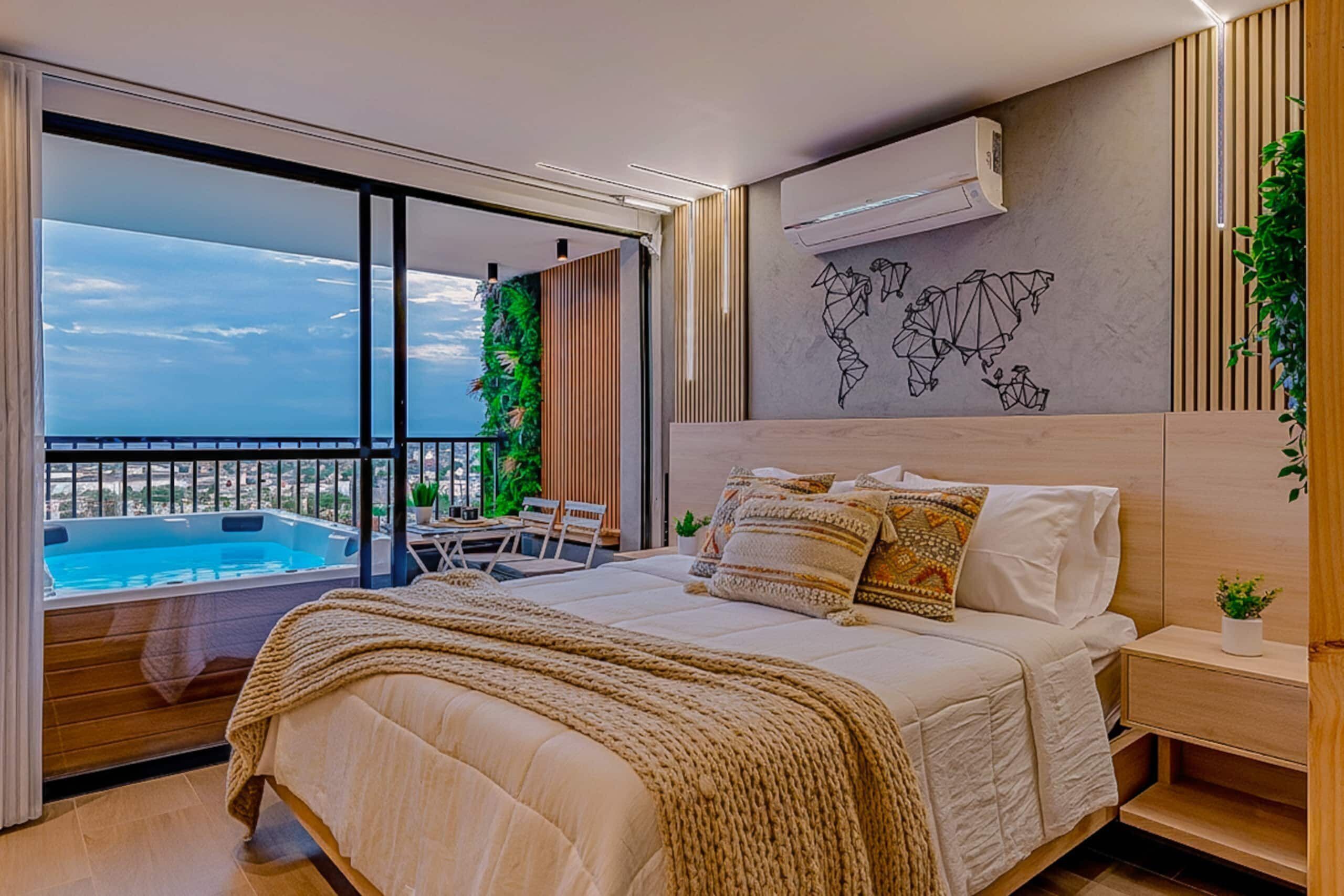 A modern bedroom with a large bed, a view of a swimming pool, and a world map on the wall.