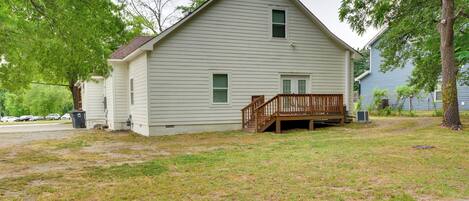 A single-story house with a front porch, a small deck, and a garage.