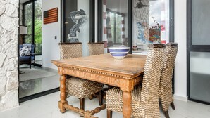 A dining area with a wooden table, woven chairs, and a decorative bowl. - Private Xpu Ha Beach Access: 6,700-sq-ft Villa (Xpu-Ha)