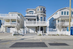 A multi-story residential building with a balcony, a garage, and a stone tower. - Family Home w/ 5 Decks! Fantasy Island Down Street (Beach Haven)