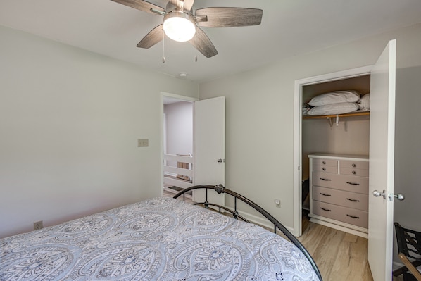 A bedroom with a bed, a ceiling fan, a wardrobe, and a door leading to a hallway. - Swim Dock Access! Moneta Escape, 5 Mi to Boat Ramp (Moneta)