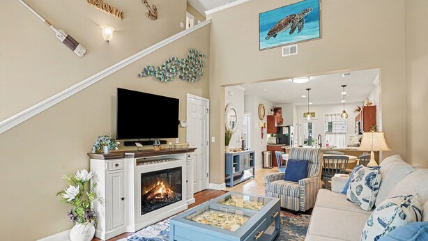 Una sala de estar con chimenea, televisor, mesa de centro y sofá.