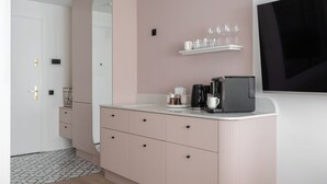 A modern bathroom with a pink vanity, a mirror, a coffee maker, and a shelf with glasses. - Love Story Studio with Jacuzzi Sopot (Sopot)