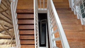 A staircase with white railings leading to a dark interior. - Oporto Riverside Apartments (Porto)