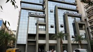 A modern hotel building with two signs reading 'HOTEL THE AVANTA' on the 4th floor.