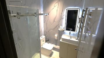 Shower, hair dryer, slippers, toilet paper