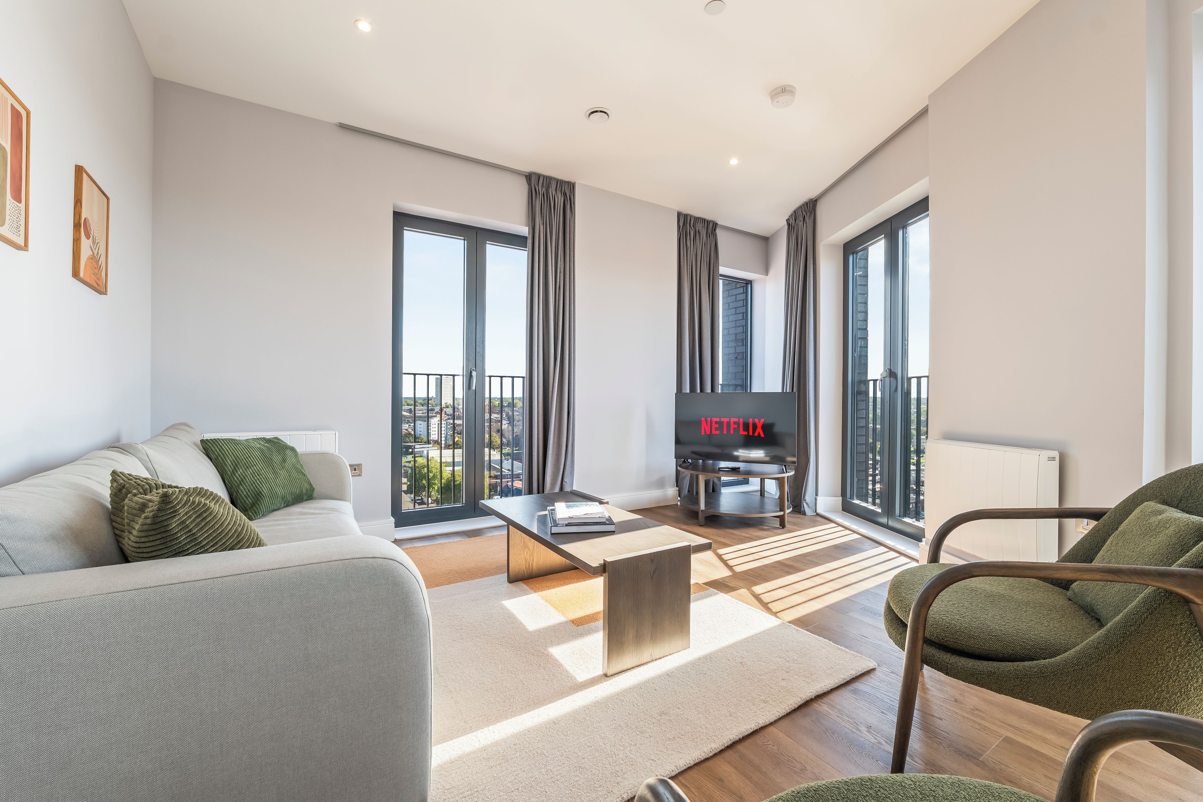 A modern living room with a sofa, coffee table, and a TV.