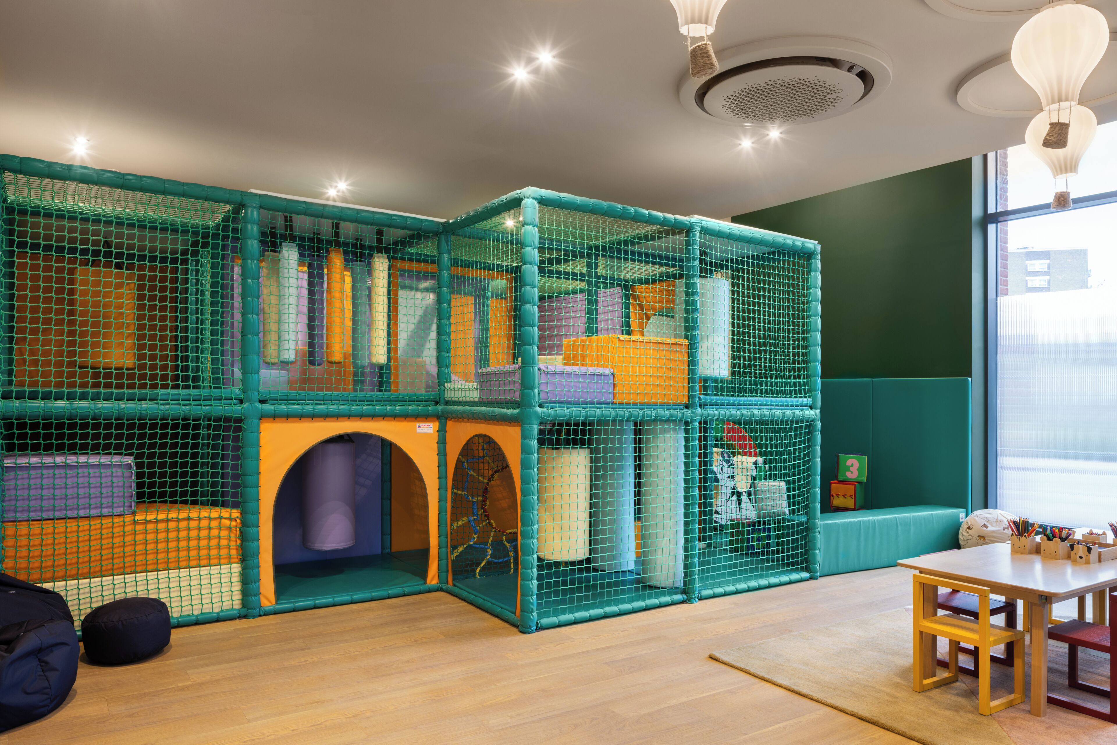A play area with a net enclosure, a table, and a bench.