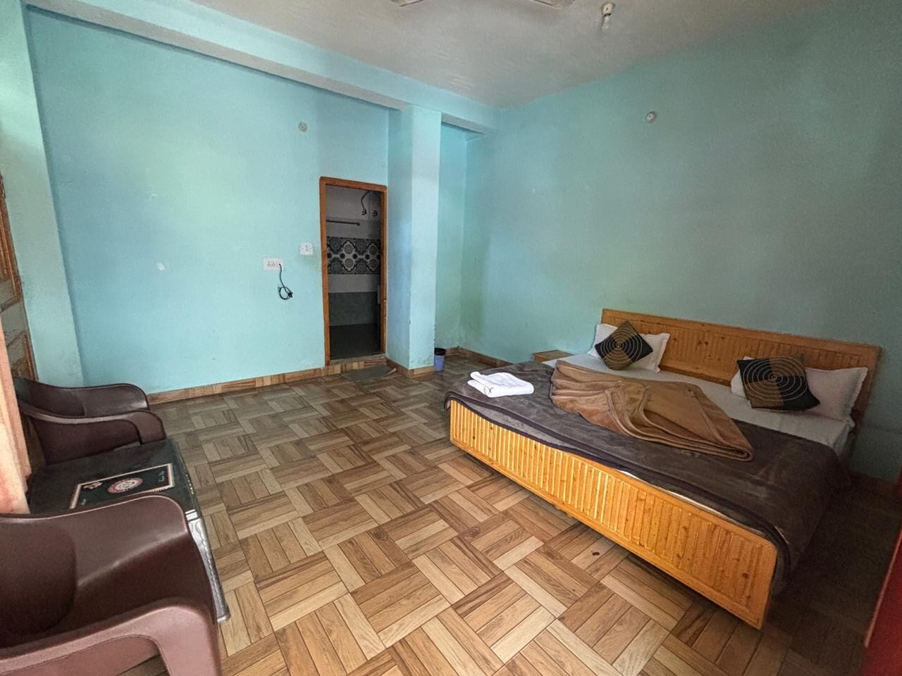 A room with a bed, a desk, and a chair.