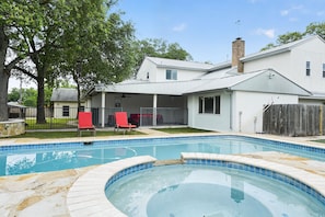 A backyard with a swimming pool, a covered patio, and a wooden fence. - San Antonio Retreat 5br Sleeps 9 near Fiesta Tx 5 Bedroom Home (San Antonio)
