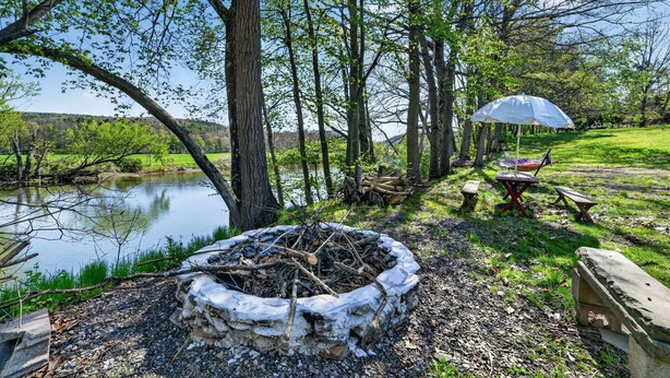 A campsite with a fire pit, picnic tables, and a tent. - Unadilla Riverfront Oasis 3br Sleeps 8 3 Bedroom Home (Unadilla)