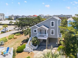 A two-story house with a balcony, a driveway, and a view of other houses. - "Better Together" 4 bed, 2.5 bath , sleeps 10 provides your home away from home. (Ocean Isle Beach)