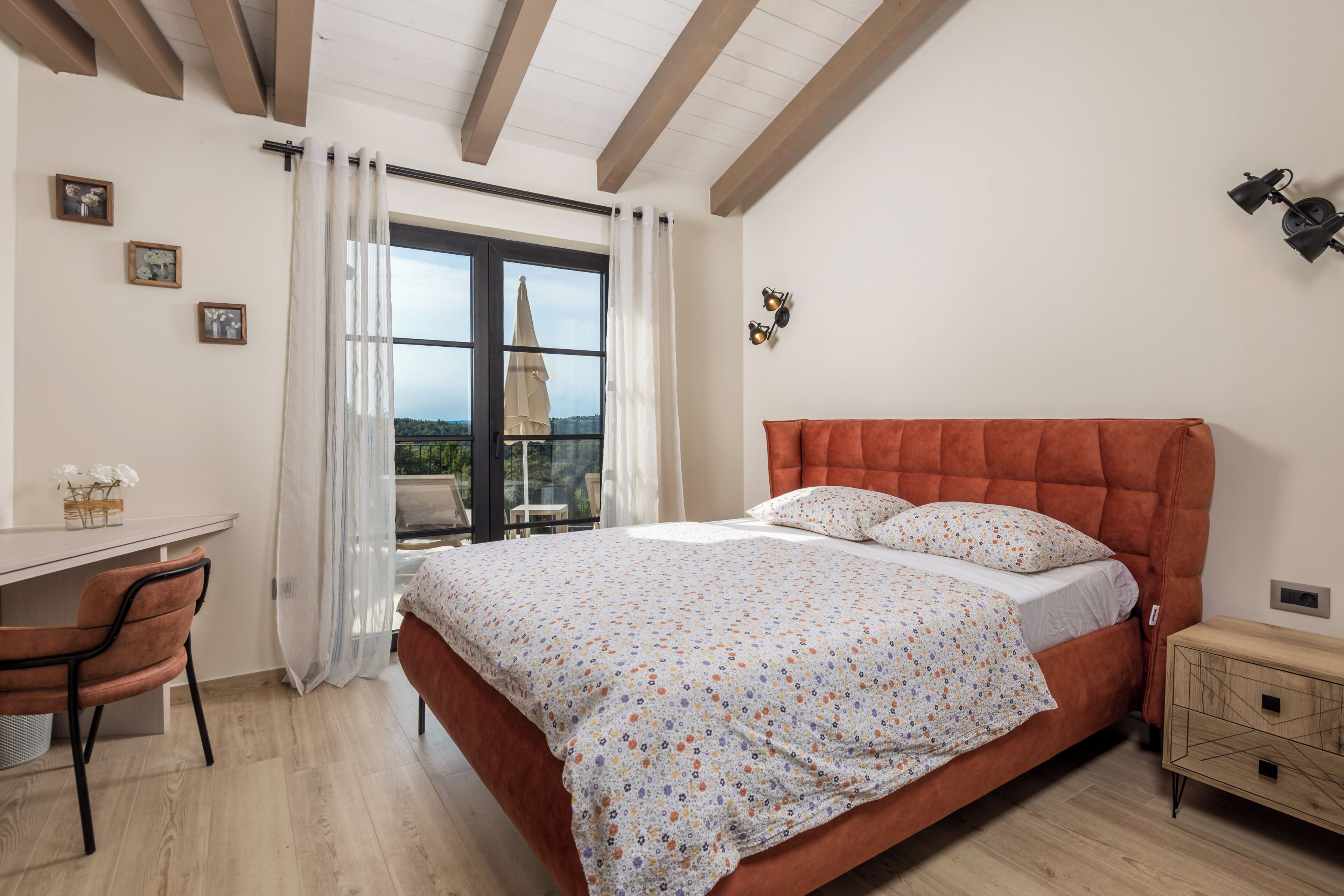 Ein Schlafzimmer mit einem Bett, einem Schreibtisch und einem Sessel.
