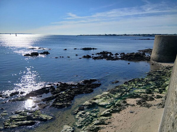 A coastal scene with clear water, rocks, and a concrete structure. - Ti ar Mor Bihan (Riantec)