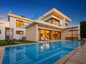 A modern two-story house with a swimming pool, large windows, and a well-maintained lawn. - Exclusive-use villa with private chef and heated pool, above Taghazout Bay (Taghazout Bay)