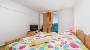 A hotel room with a bed, a television, a desk, and a window with a view. - Apartman Butterfly 2 - Opatija by Villas Guide (Brsec)