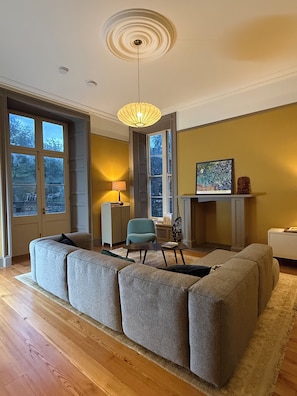 A modern living room with a sectional sofa, a lamp, a chair, and a fireplace. - Sleeps 16 | Georgian Manor, Yorkshire Dales, Dent | Dog-friendly, 5 acres (Dent)