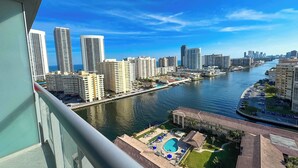 A high-rise building with a view of a river and cityscape. - 1BR · Intracoastal View · Balcony · Gym & Pool (Hallandale Beach)