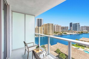 A balcony with a view of a marina and high-rise buildings. - Beachwalk Studio | Sunset & Balcony (Hallandale Beach)