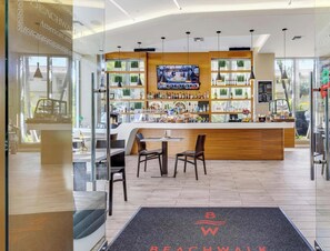 Eine moderne Bar mit Fernseher, Holztresen und Sitzgelegenheiten.