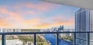 A high-rise building with a view of a city skyline and a river. - Top-Floor 1BR · Bay View · Beachwalk Resort & Gym (Hallandale Beach)