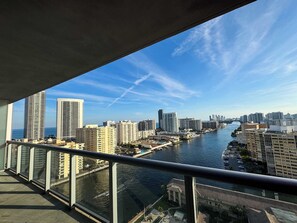 A high-rise building with a river view, modern architecture, and a clear sky. - Sunset View Apt | Pool, Gym & Beach Shuttle (Hallandale Beach)
