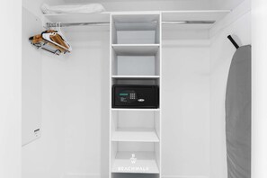 A white closet with shelves, a hanging rack, and a microwave. - Stylish Studio - Top Amenities & Bay View (Hallandale Beach)