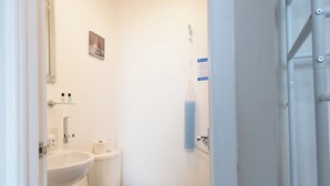 A bathroom with a sink, toilet, and a towel rack. - Bayview Aparthotel by Guestz (Morecambe)