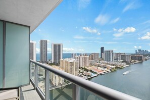 A high-rise building with a view of a marina and city skyline. - Cozy Upper Studio - Beach access & Private Balcony (Hallandale Beach)