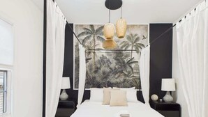 A bedroom with a bed, two bedside tables, a canopy bed, a wall mural, and hanging lamps. - Historic Estate | 10 BR, Sleeps 16+, Game Room (Chicago)
