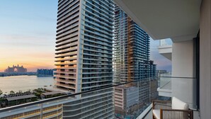 A high-rise building with multiple balconies, a view of the water, and a distant landmark. - LUX  The Beach Mansion Sea View Suite (Dubai)
