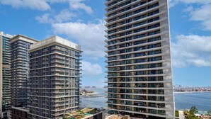 A high-rise building with multiple balconies, a view of the sea, and a clear sky. - LUX  The Beach Mansion Sea View Suite (Dubai)