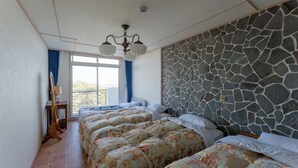 A hotel room with a stone wall, a bed with floral bedding, a wooden chair, and a ceiling light fixture. - Luce Suzaki (Shimoda)