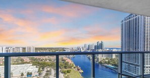 A high-rise building with a view of a city skyline and a river. - Elegant 1BR · Intracoastal View · Pool & Gym (Hallandale Beach)