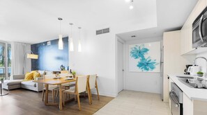 A modern kitchen with a built-in oven, a sink, and a microwave. - Marina Views  2BR  Beachwalk Resort (Hallandale Beach)