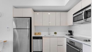 A modern kitchen with stainless steel appliances, a dishwasher, and a microwave. - Stunning 1BR · Gym & Resort Pool (Hallandale Beach)