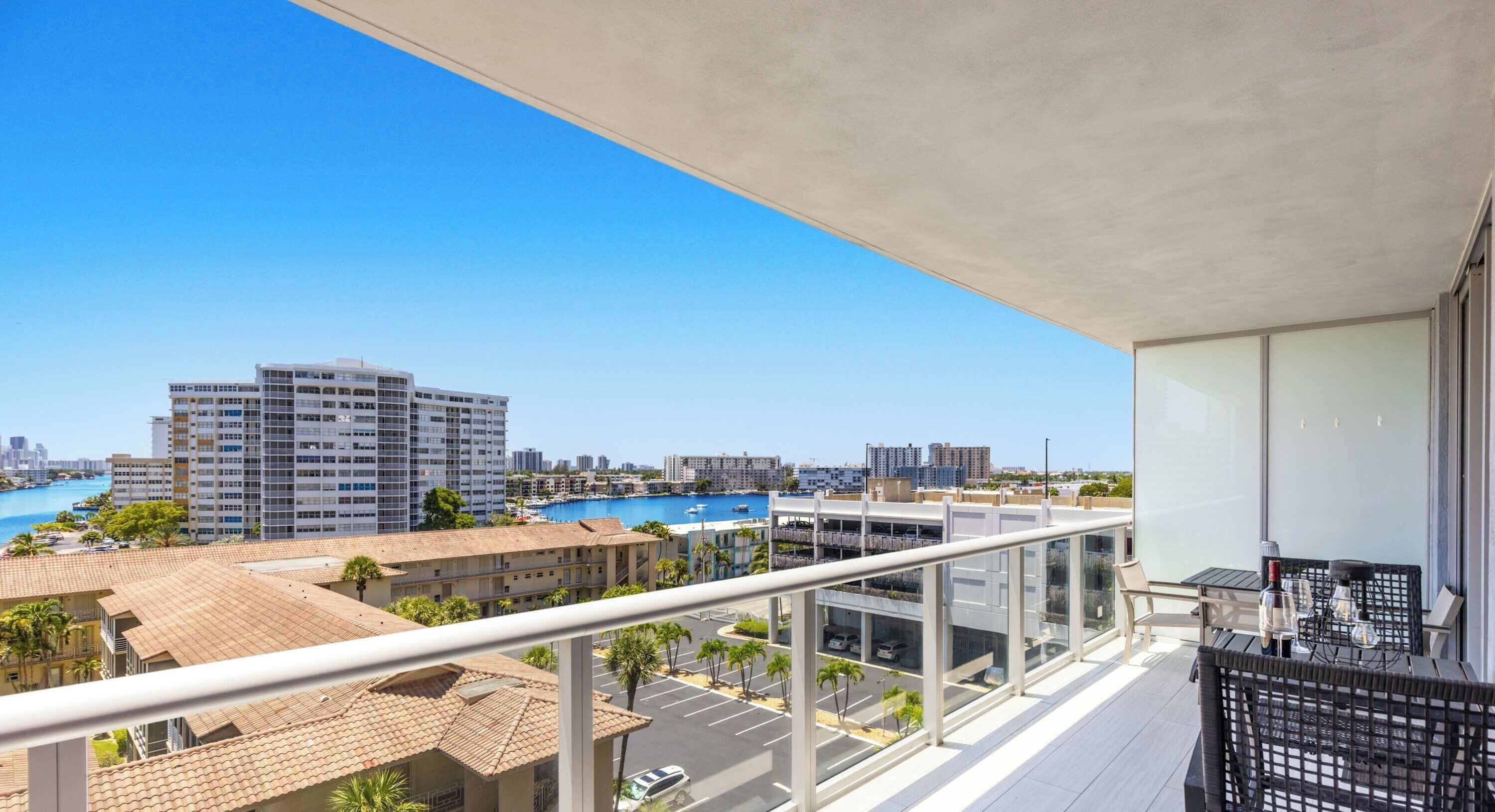 A balcony with a view of a marina and buildings.