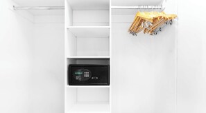 A white wardrobe with a digital lock and wooden hangers. - Cozy Apt - Living  2BR Gym &  Pool (Hallandale Beach)